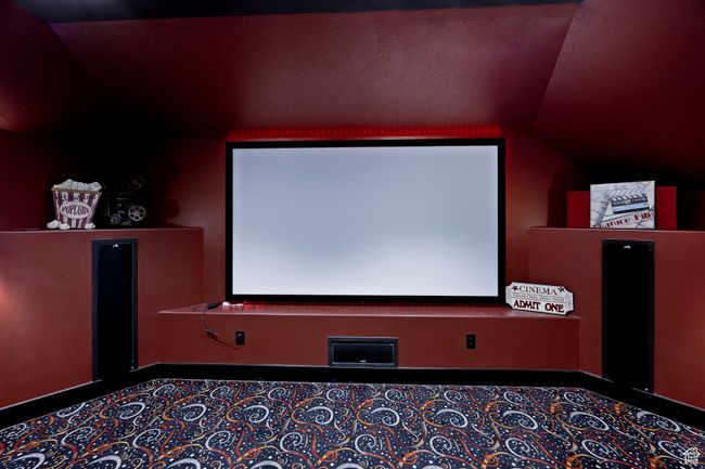 Home theater room featuring vaulted ceiling and 120" projection screen. | Image 53