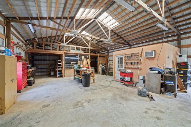 The enormous workshop offers a horse stall, tack room, overhead storage, and tons of space for all your recreational needs | Image 39