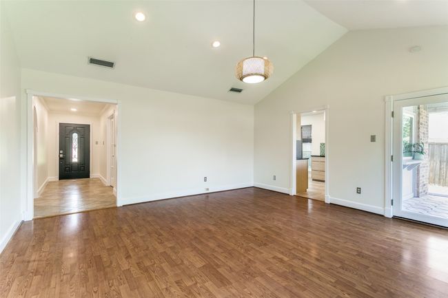 Den with view of entry and kitchen. | Image 17