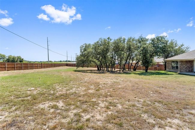 Oversized back yard with cluster of trees for ample shade. | Image 36