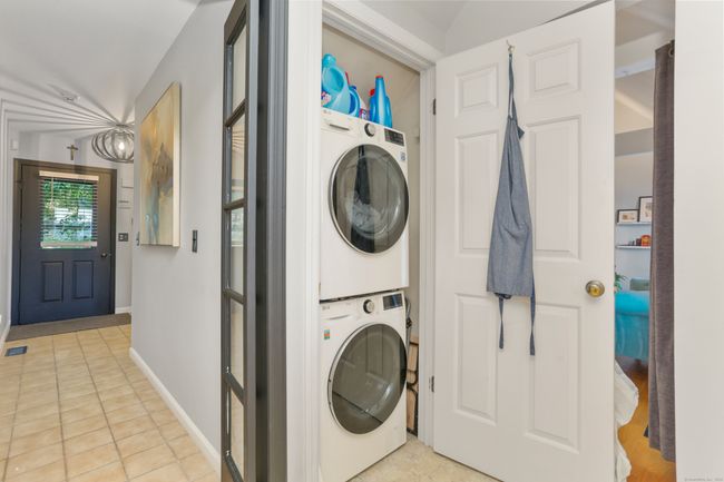 A washer and dryer, new in 2023, are conveniently located in a utility closet in the kitchen. | Image 12
