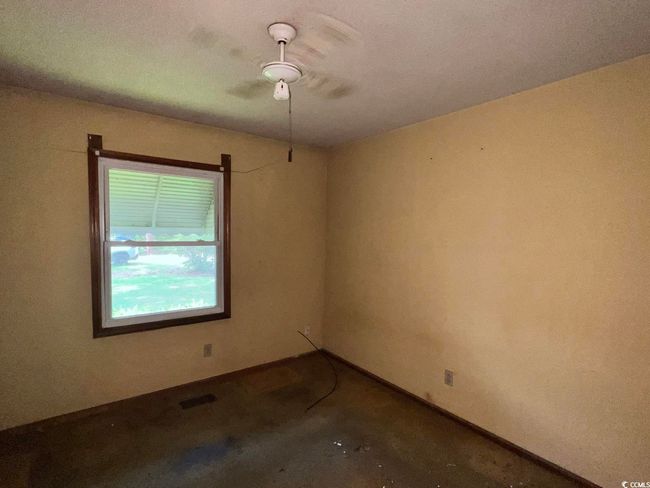 Spare room with ceiling fan and carpet floors | Image 16