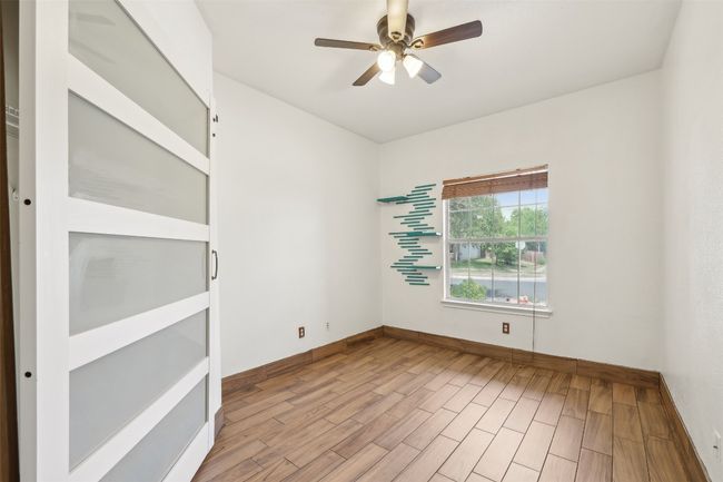 Empty room featuring a ceiling fan, baseboards, and wood finished floors | Image 18