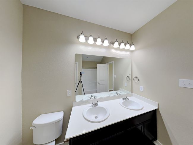 Bathroom featuring double vanity and a shower | Image 14