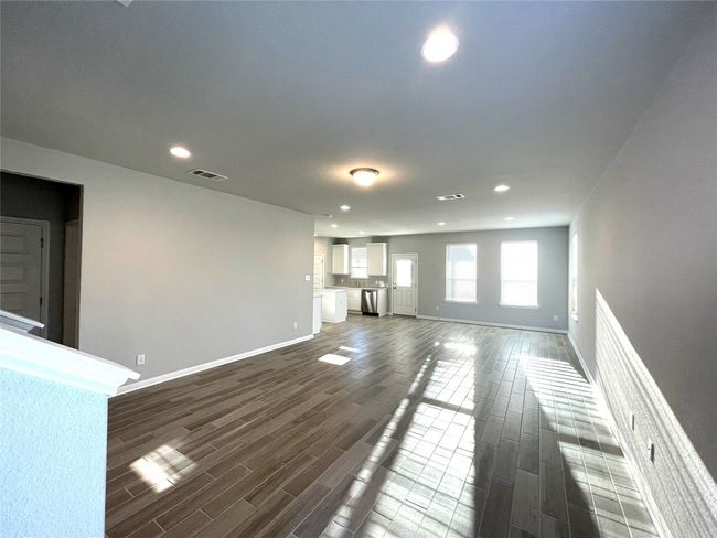 Unfurnished living room featuring recessed lighting and dark wood finished floors | Image 5