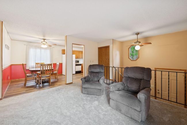 View from the patio door into the living room and adjoining casual dining area. | Image 8
