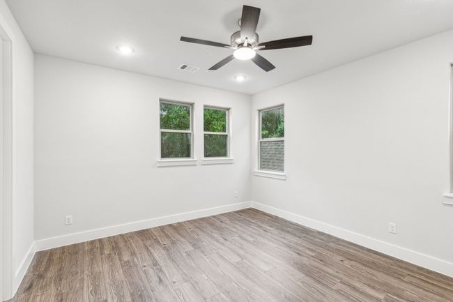 Primary bedroom room featuring wood finished floors, ceiling fan, and recessed lighting | Image 25