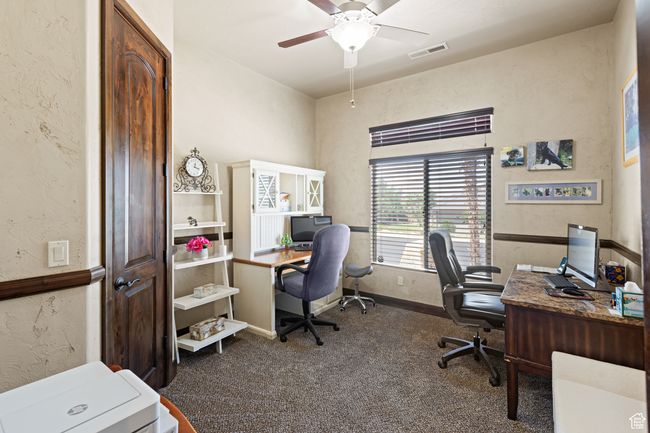 Office with carpet floors, a ceiling fan, and a textured wall | Image 44