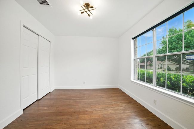 The secondary bedrooms are located at the front of the home, ideal for a guest suite or home office setup. | Image 20