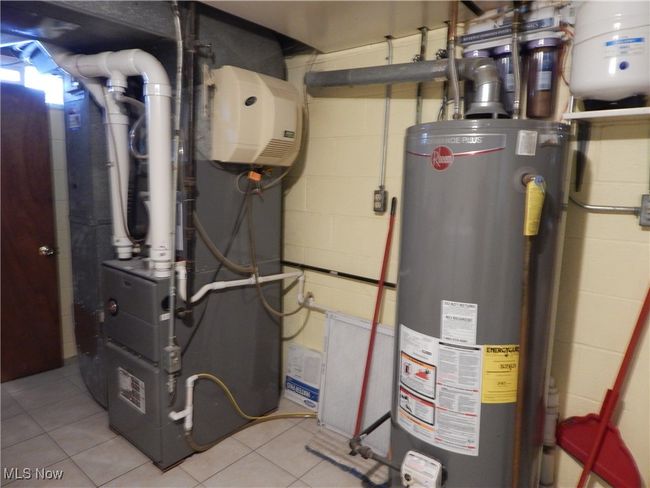 Utilities featuring updated water heater and heating unit | Image 29