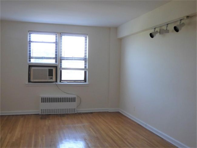 Living room lighting, cooling unit, radiator heating unit, and wood finished floors | Image 10