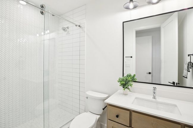 Dual vanities and timeless tile design bring elegance to everyday routines. | Image 27