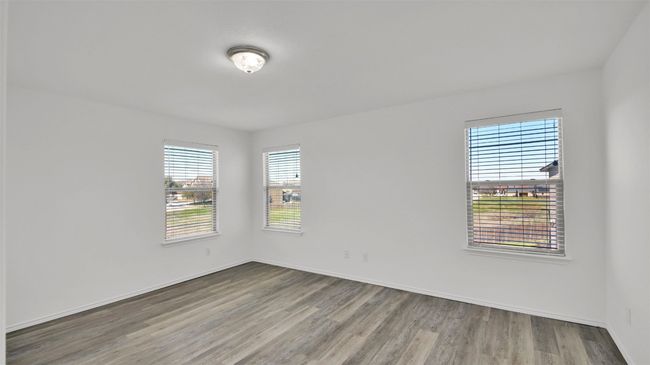Spare room featuring baseboards and wood finished floors | Image 27