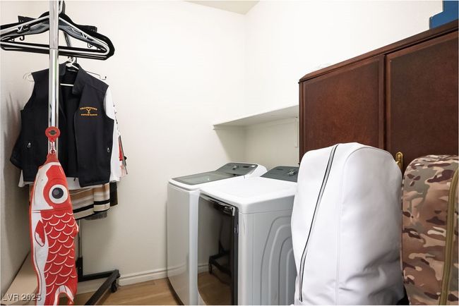 Laundry room featuring washing machine and clothes dryer, light wood-style flooring, laundry area, and baseboards | Image 24