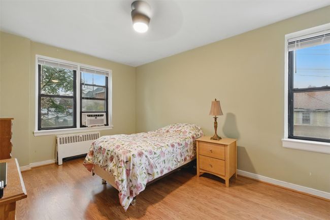 Primary bedroom with ceiling fan and south and west facing windows. | Image 11