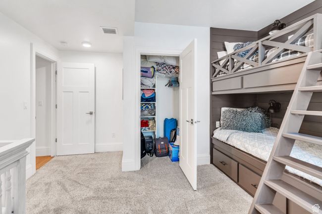 Carpeted bedroom with baseboards and a closet | Image 59