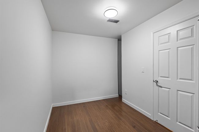 Spare room with dark wood-style floors and baseboards | Image 16