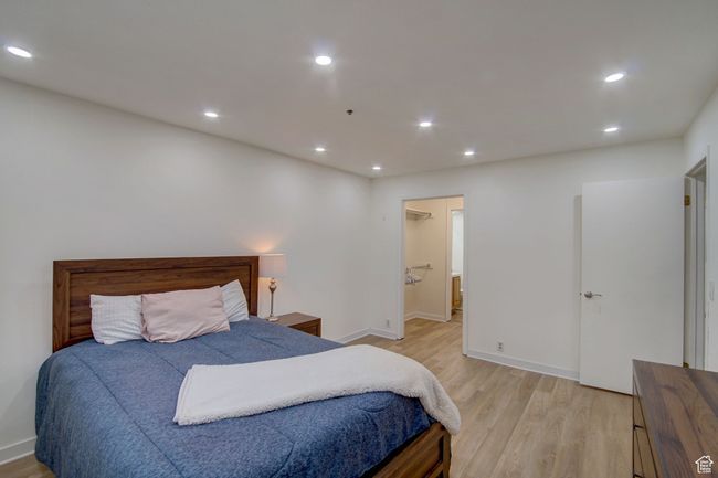 Bedroom with ensuite bathroom and light hardwood / wood-style flooring | Image 15