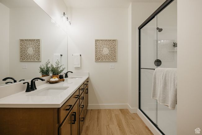 Bathroom featuring a shower stall, wood finished floors, and a sink | Image 18