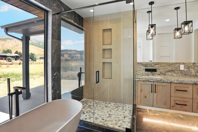 Kitchen with light stone countertops, pendant lighting, recessed lighting, and light brown cabinets | Image 33