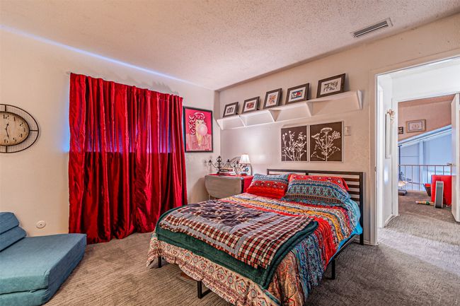Carpeted bedroom featuring a textured ceiling | Image 15