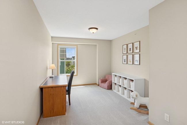 This upper-level loft offers flexible space for a home office, kids' playroom, or tv hangout | Image 24