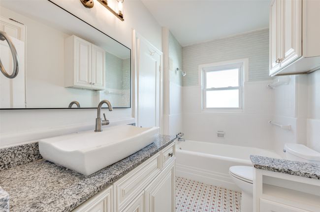 Full bathroom featuring toilet, vanity, and shower / bath combination | Image 16