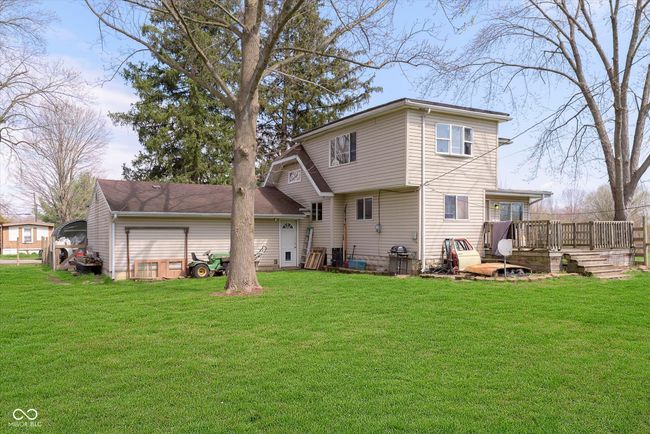 back of house featuring a deck and a lawn | Image 31
