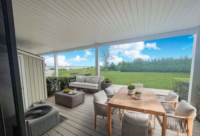 Deck with an outdoor structure, a shed, central AC, outdoor lounge area, and a lawn | Image 19