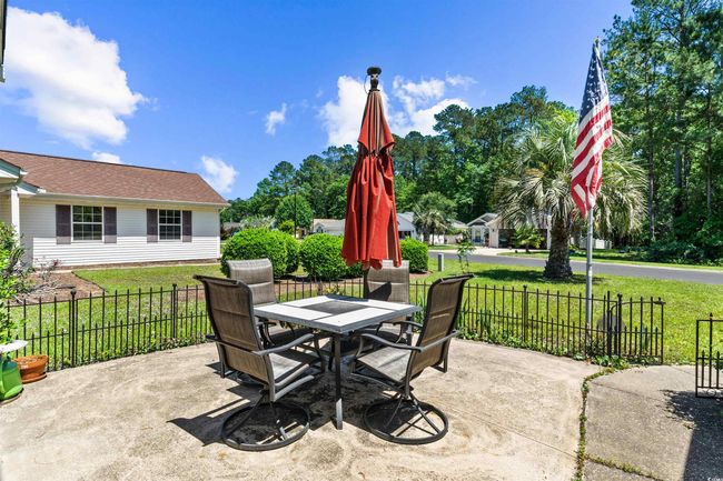 View of patio with fence and outdoor dining space | Image 34
