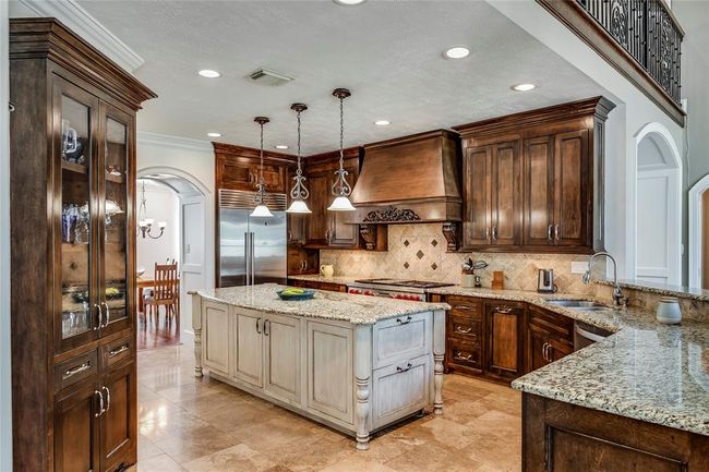 Wonderful Chef's Kitchen with huge fridge Freezer, freezer drawers & 6 gas burner gas cook top, beautiful wooden cabinets and contrasting island and high end granite counters. Fabulous for entertaining Family and friends | Image 14