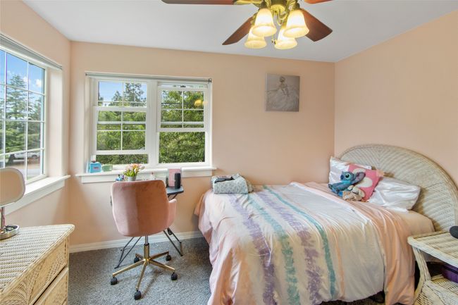 Bedroom with multiple windows, carpet, and ceiling fan | Image 63