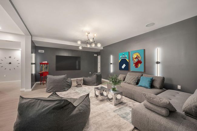 Living room with light wood-style floors, baseboards, and a chandelier | Image 14