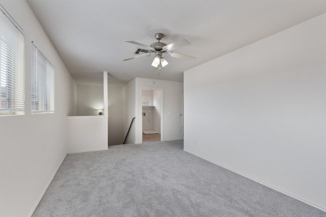 Carpeted spare room featuring ceiling fan and baseboards | Image 17