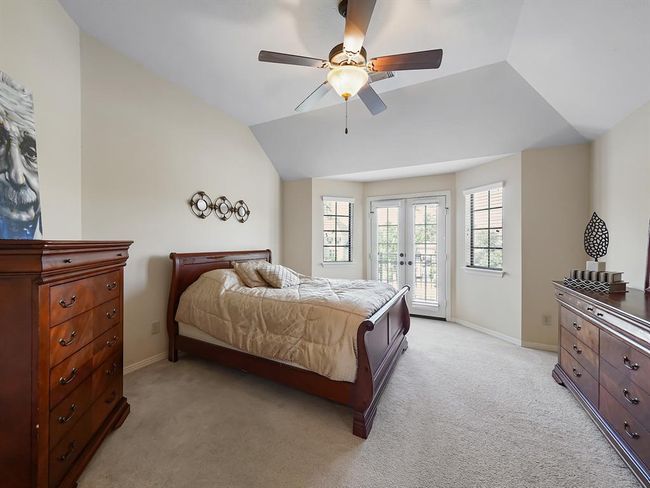 Experience serene lake views from the second-floor bedroom's balcony, complete with an ensuite bathroom. | Image 37