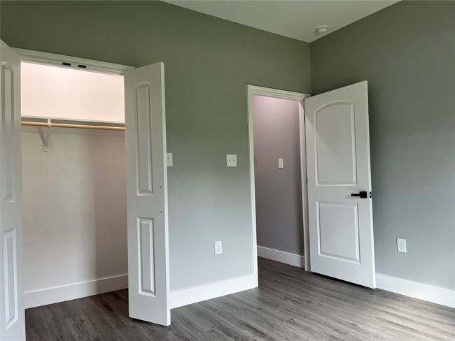 Unfurnished bedroom with wood finished floors and a closet | Image 16