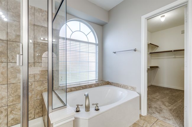 Bathroom featuring a spacious closet, a garden tub, tile patterned floors, and a stall shower | Image 16