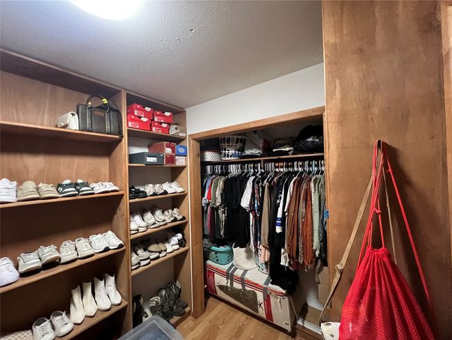 Walk in closet with wood finished floors | Image 16