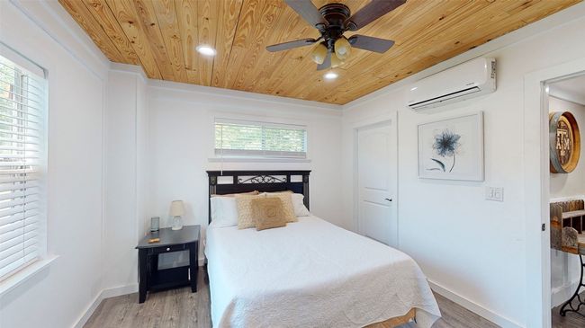 Bathroom featuring tile walls, ceiling fan, a washtub, vanity with extensive cabinet space, and crown molding | Image 15