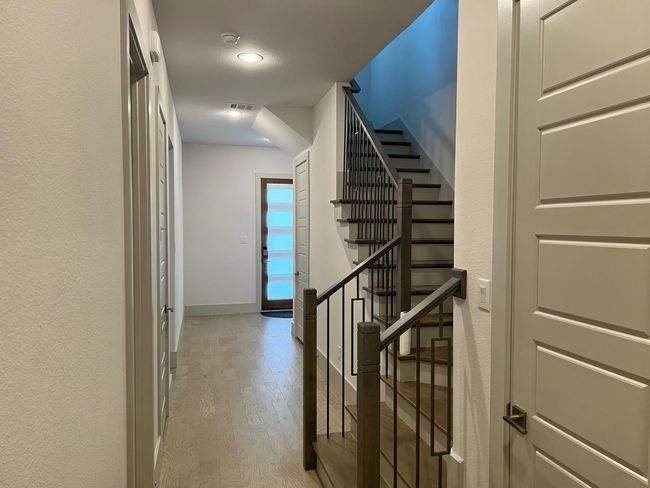 Staircase featuring wood finished floors and baseboards | Image 11