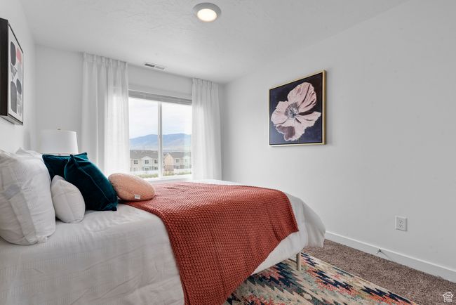 Carpeted bedroom featuring baseboards and a mountain view | Image 12