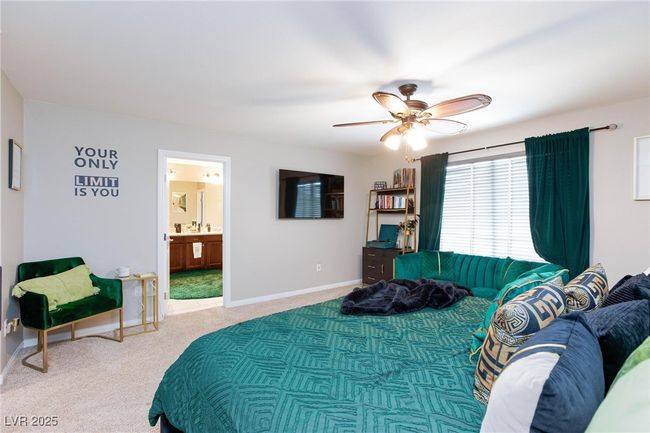Carpeted bedroom with ceiling fan, ensuite bath, and baseboards | Image 22