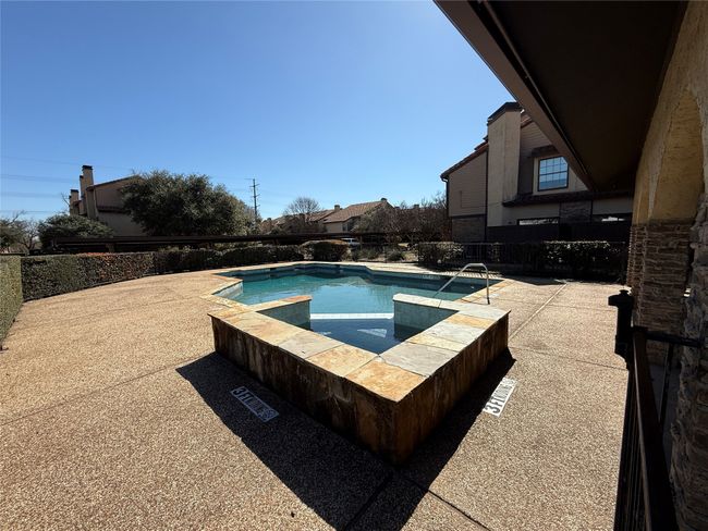 View of swimming pool featuring a patio, fence, and a hot tub | Image 30
