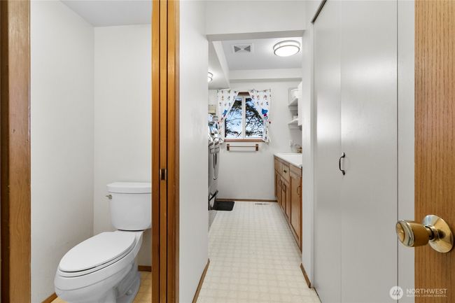 Utility room with a pocket door to a half bath. | Image 25