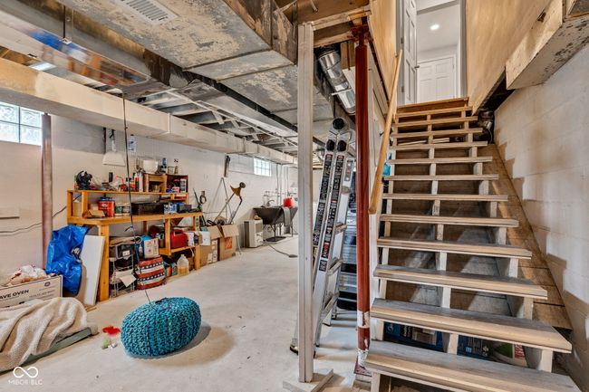 Basement with stairway, plenty of natural light, and a sink/laundry area. | Image 44