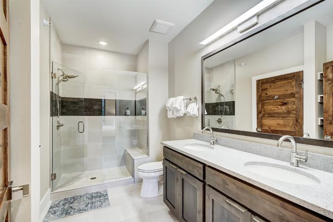 Full bathroom with a stall shower, tile patterned flooring, and a sink | Image 24