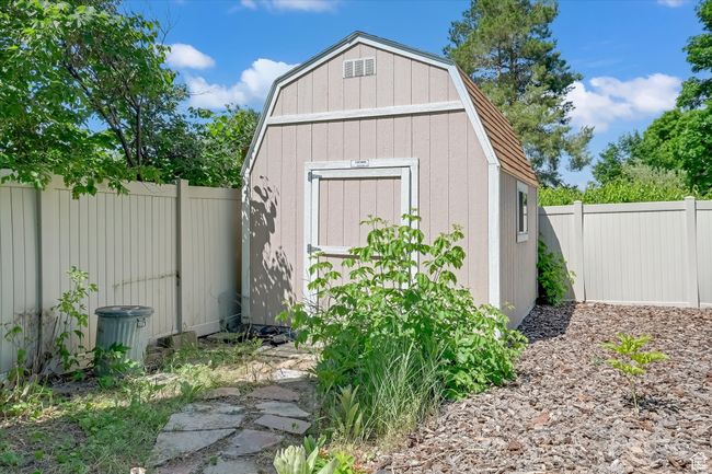 View of shed featuring a fenced backyard | Image 36