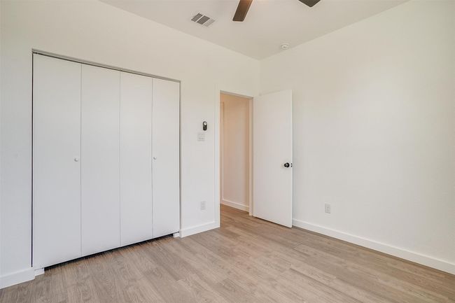 Unfurnished bedroom featuring light wood-style floors, a closet, baseboards, and visible vents | Image 25