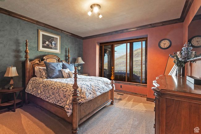 Bedroom with ornamental molding, baseboards, and carpet | Image 39
