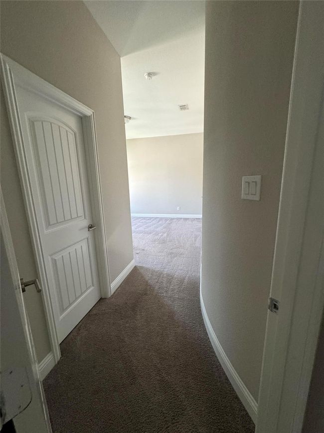 Hallway with carpet and baseboards | Image 38